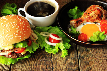 Fried eggs, omelet traditional rustic breakfast, fried eggs, roasted bacon, sausage for breakfast on a wooden table background.  Healthy food