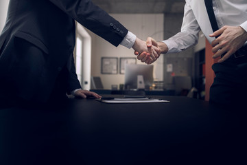Men are shaking hands after meeting in office - obrazy, fototapety, plakaty