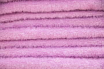 Pink  terry towel. A stack of soft bath accessories.