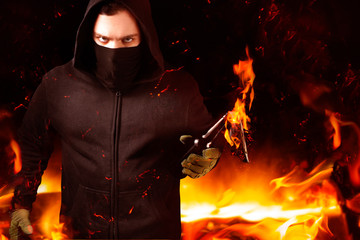 Protestant holding burning molotov cocktail.