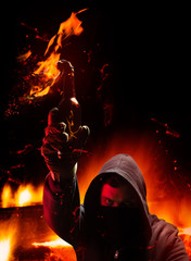 Protester holding burning molotov cocktail. Vertical oriented photo.