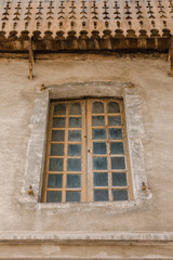 Old wooden double window set in ancient stone wall, Provence