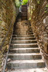 Fototapeta na wymiar narrow outdoor stone stairway between drystone walls