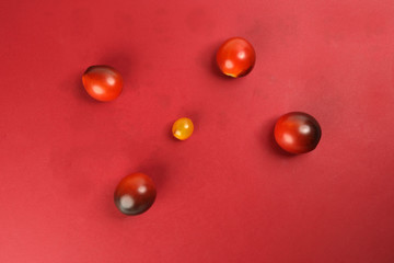 Fresh ripe mixed tomato verity assorted color on red background