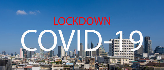 COVID-19 coronavirus outbreak text on skyscraper modern city tower, office building to prevent...