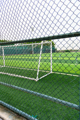 a soccer field behind the fence