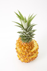 Whole pineapple with slice on white background, tropical fruit.