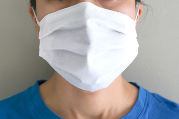 A man with flu and sneezing, he uses  protective mask  to prevent runny nose.