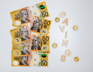 Australian dollars 50 banknotes and coins. Savings concept
