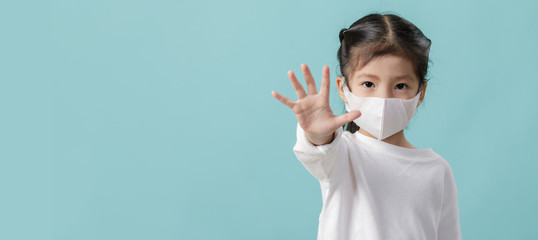 Asian little child girl is wearing medical face masks to protect themselves from pollution Coronavirus flu virus, New coronavirus 2019-nCoV from China, Empty space isolated on blue long banner - Powered by Adobe