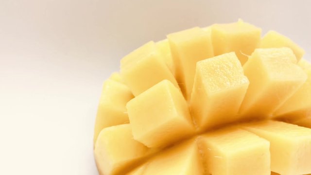Yellow  mango slice with cubes isolated white background
