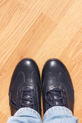Navy blue leather shoes for men on wooden background, copy space for inscription