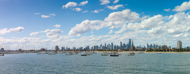 Panoramic of the city of Melbourne against a sunny blue sky seen from St Kilda pier looking through...