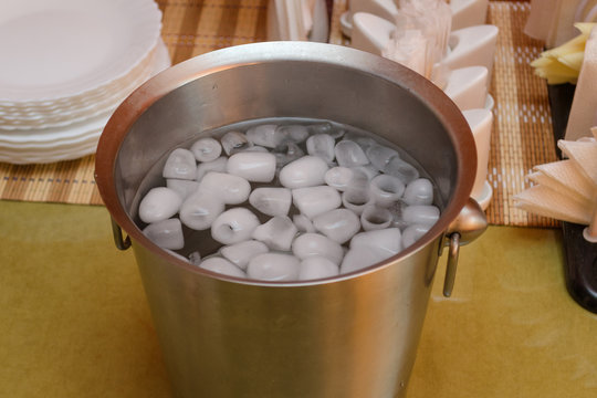 ice with water in a metal bucket for cooling alcoholic beverages