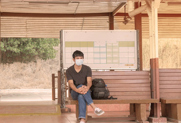 Obraz na płótnie Canvas man sitting on bench and looking at camera
