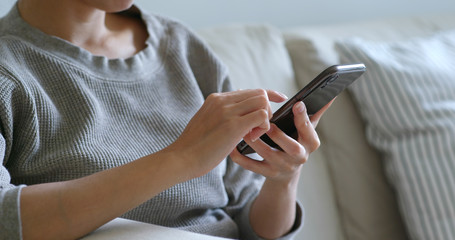 Woman use of mobile phone at home