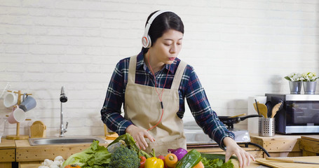 Gorgeous young asian japanese woman preparing dinner in modern bright kitchen. concept cooking...