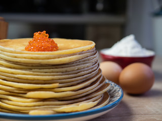 Traditional Russian pancakes with red caviar.