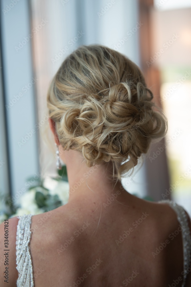 Poster vertical closeup shot of the beautiful wedding hairstyle of the blonde bride