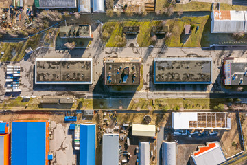aerial view of suburb industrial area with group of modern warehouses, factory buildings and distributions centers. industrial district background