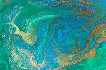 Mixes blue and gold inks abstract texture.