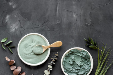 Blue cosmetic clay on black background top-down copy space