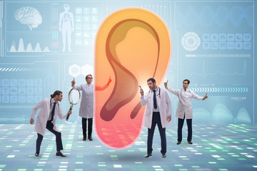 Doctor examining giant ear in medical concept