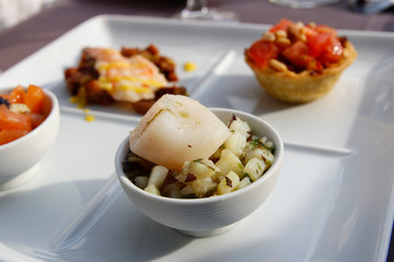 Focus on the scallop flavoured with lime leaf, diced potatoes with seaweed preserve as the starter for dinner in Paris