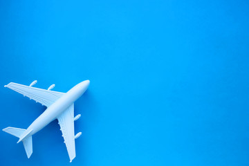 Model airplane on a blue background. Space for text. Travel concept.