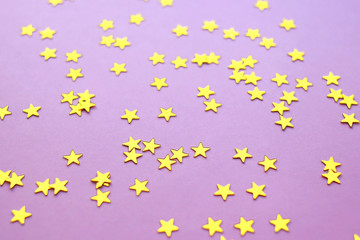 Golden stars glitter on pink background. 