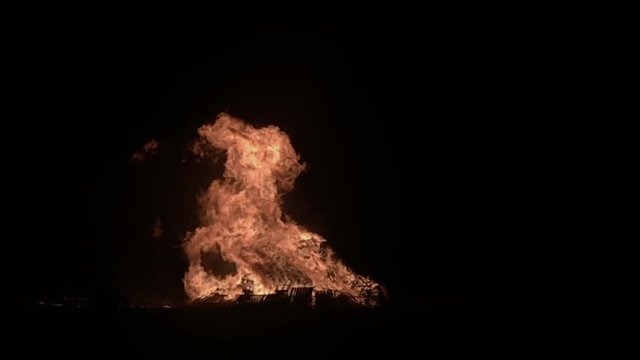 Huge bonfire burning with large flames leaping up