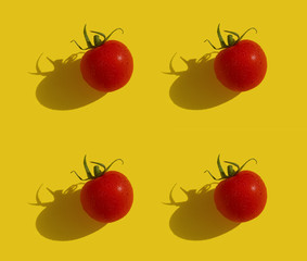 Cherry tomato on a yellow background seamless pattern