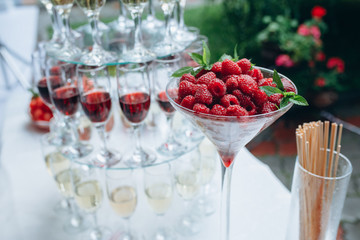 Fototapeta na wymiar fruit salad of raspberry, mint, grapes in a glass sundae dish, close up.