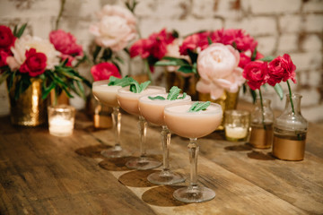 An array of pink-colored creamy  alcoholic drinks ready to be served