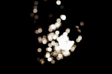 Sun glare on a black background. White sparkling abstract. Festive concept. Bokeh. 