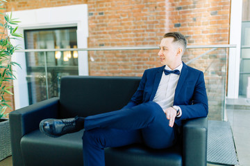  Portraits of a man in a jacket on a neutral background. Stylish portraits of the happy groom.