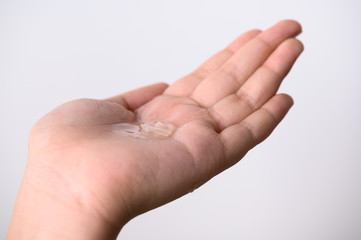 Hands Applying Sanitizer Gel. hands using wash hand sanitizer gel dispenser, against Novel coronavirus or Corona Virus Disease (Covid-19) at public train station. Antiseptic, Hygiene and Healthcare