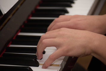 Fototapeta na wymiar close up fingers playing piano