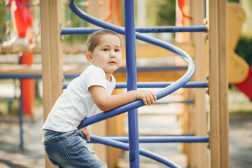 Child in a summer park. Boy on a playground.