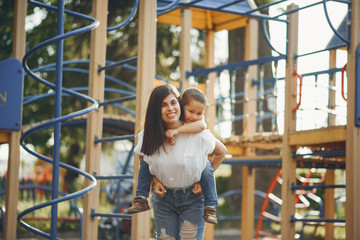 Family in a park. Mother with son. People on a playground.