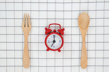 Meal time with alarm clock for breakfast , healthy food concept on table background