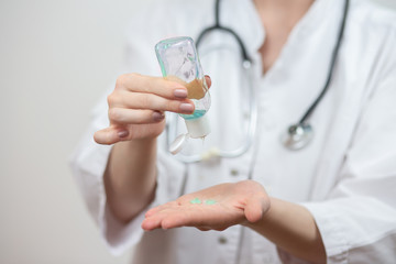 Female doctor use hand sanitizer to help prevent virus infection and plague.