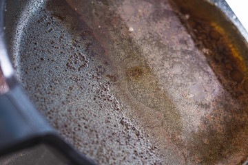 Dirty pan with cooking oil close up still