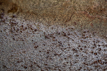 crumbs and burnt cooking oil on a black pan close up still