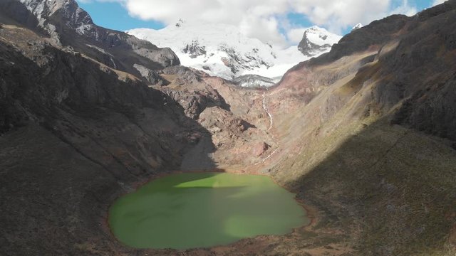 Green lake shallap, inmersive frontal flying, lake product of the defrosting glaciers, peruvian andes.