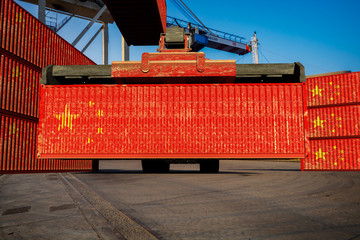 Unloading containers with the Chinese flag at the port quay