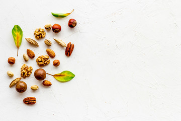 Nuts background - healthy snacks concept - on white table top-down frame copy space