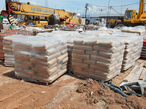 SEREMBAN, MALAYSIA -MARCH 12, 2020: Cements that has reached the construction site. Packed in a durable bag and placed on a wooden pallet.