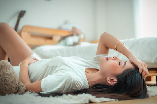 Beautyful Asian woman sitting relax on the bed.