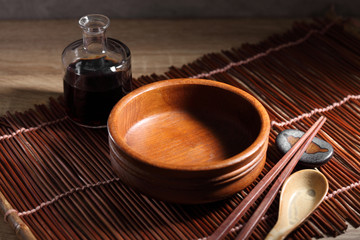 Chopsticks and cup on wooden table, Japanese utensil in rustic backgrounds